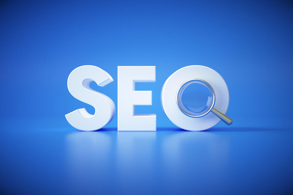 The word seo with a magnifying glass on a blue background.